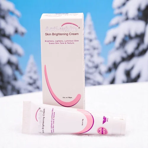 Actiwhite Skin Brightening Cream, 30g white tube with pink accents, and its matching white and pink box, set against a snowy background with pine trees.
